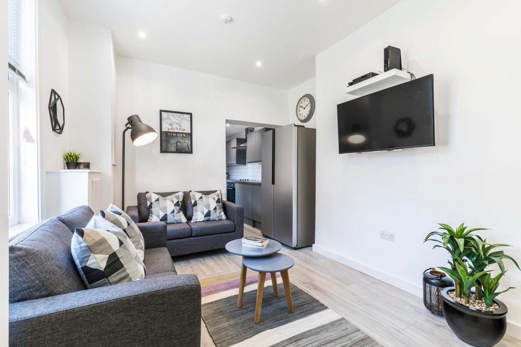 A modern, spacious living room featuring a comf...