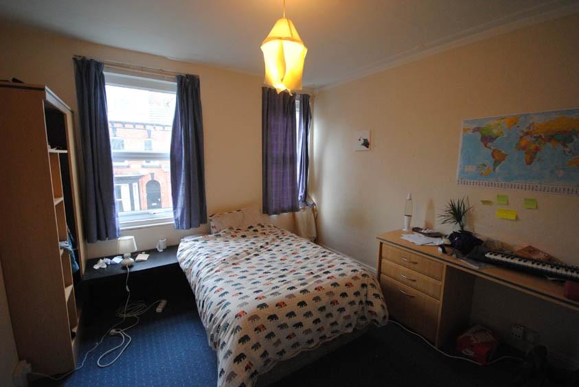A cozy student bedroom featuring a double windo...