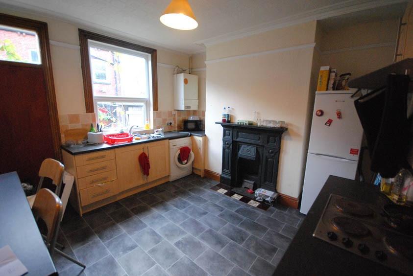 A cozy kitchen featuring a large window that al...