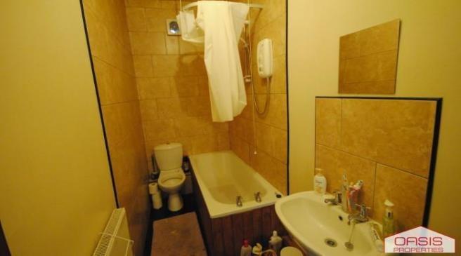 A spacious bathroom featuring a large bathtub, ...