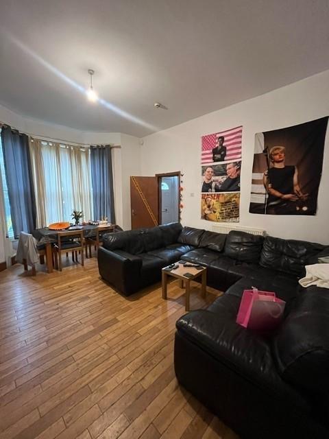 A spacious, well-lit living room featuring a la...