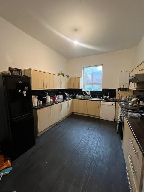 A spacious, well-lit kitchen with ample cabinet...