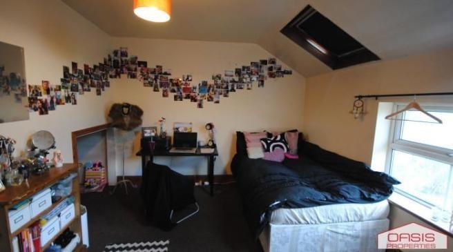 A cozy bedroom featuring a comfortable double b...