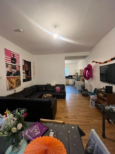 A spacious and well-lit living room featuring a...