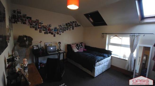 A well-maintained bedroom featuring a double be...