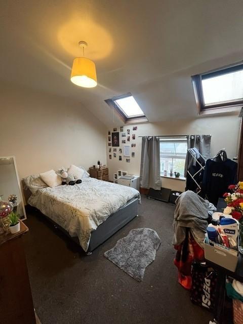 A cozy bedroom featuring a double bed, with nat...