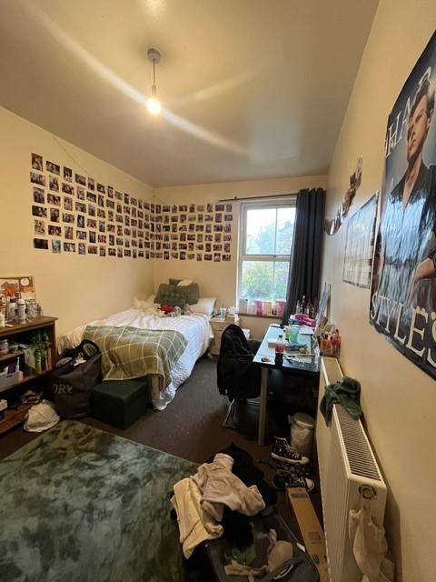 A cozy, well-used bedroom with ample space for ...
