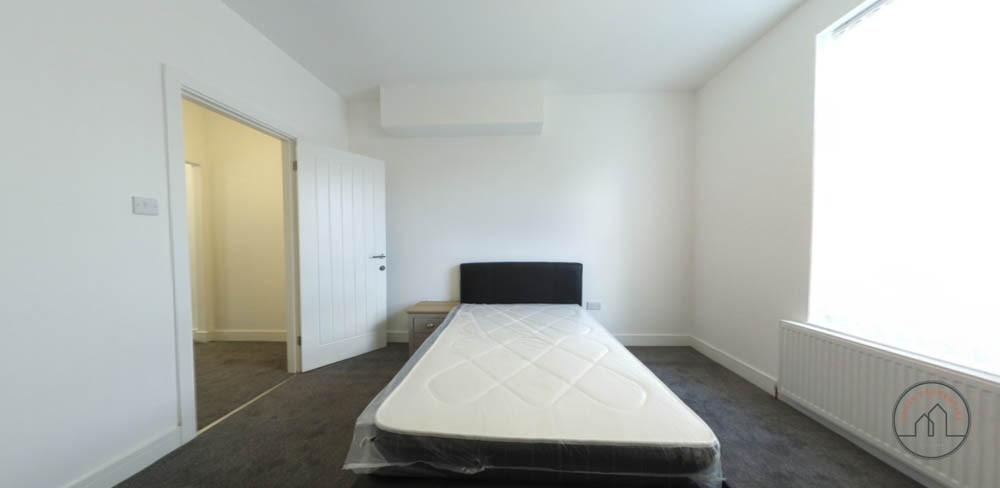 Bright and spacious bedroom featuring a comfort...