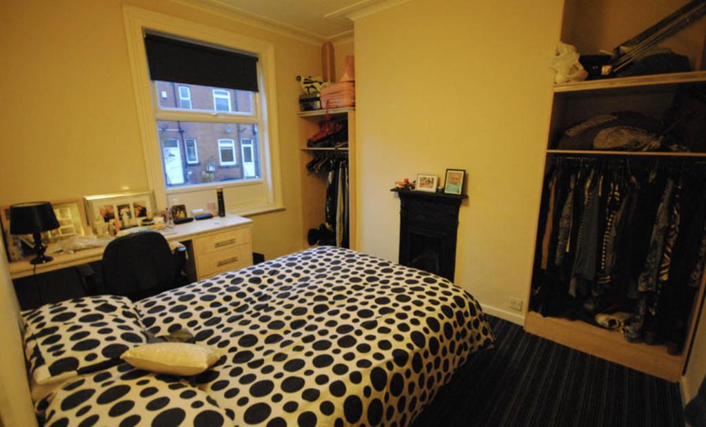 A cozy bedroom featuring a double bed with a po...