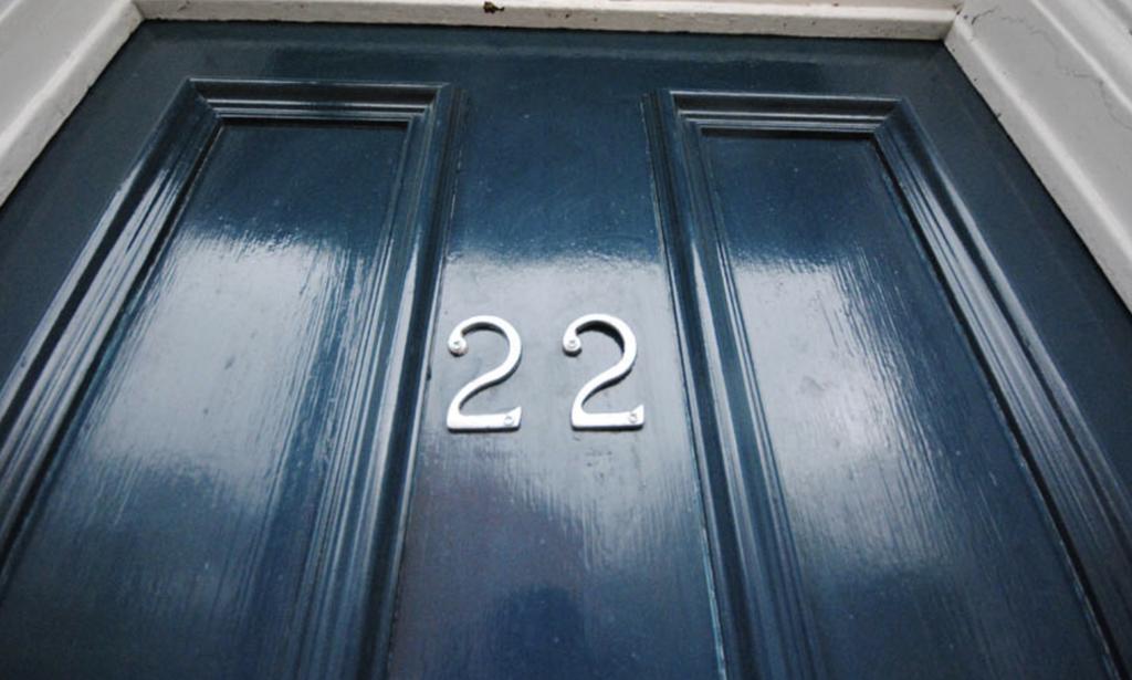 A charming front door with the house number '22...