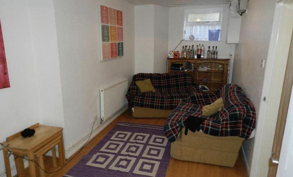 A cozy and well-lit living room featuring a com...