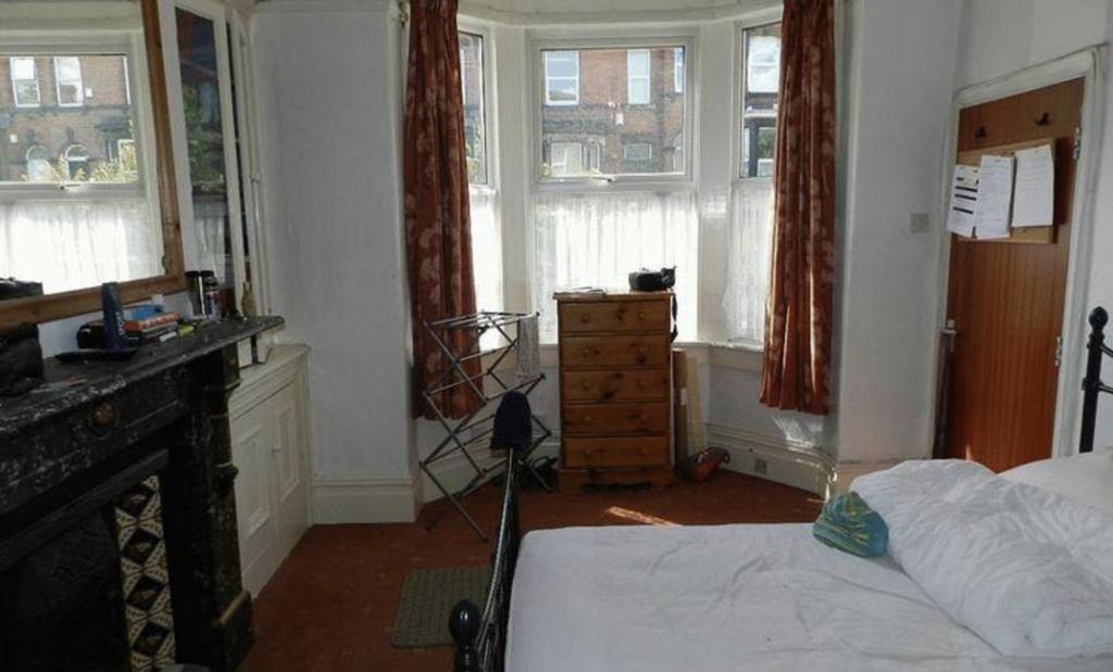 A cozy and well-maintained bedroom featuring a ...