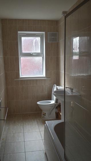 A well-maintained bathroom featuring a toilet, ...