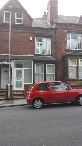A traditional brick-fronted house with a white ...