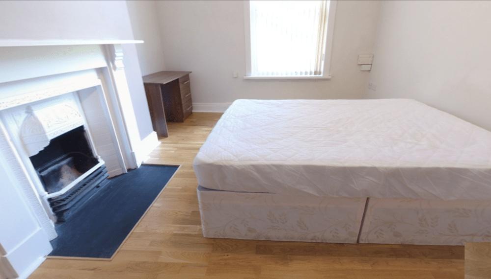 Spacious master bedroom featuring a comfortable...