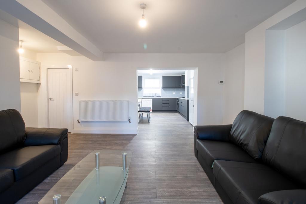 A spacious and modern living room featuring com...
