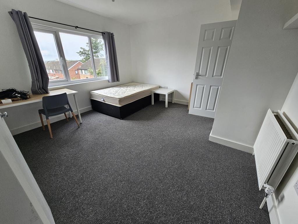 A bright and spacious double bedroom featuring ...