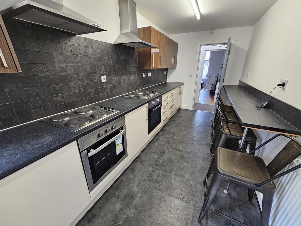 Bright and modern kitchen with sleek black coun...