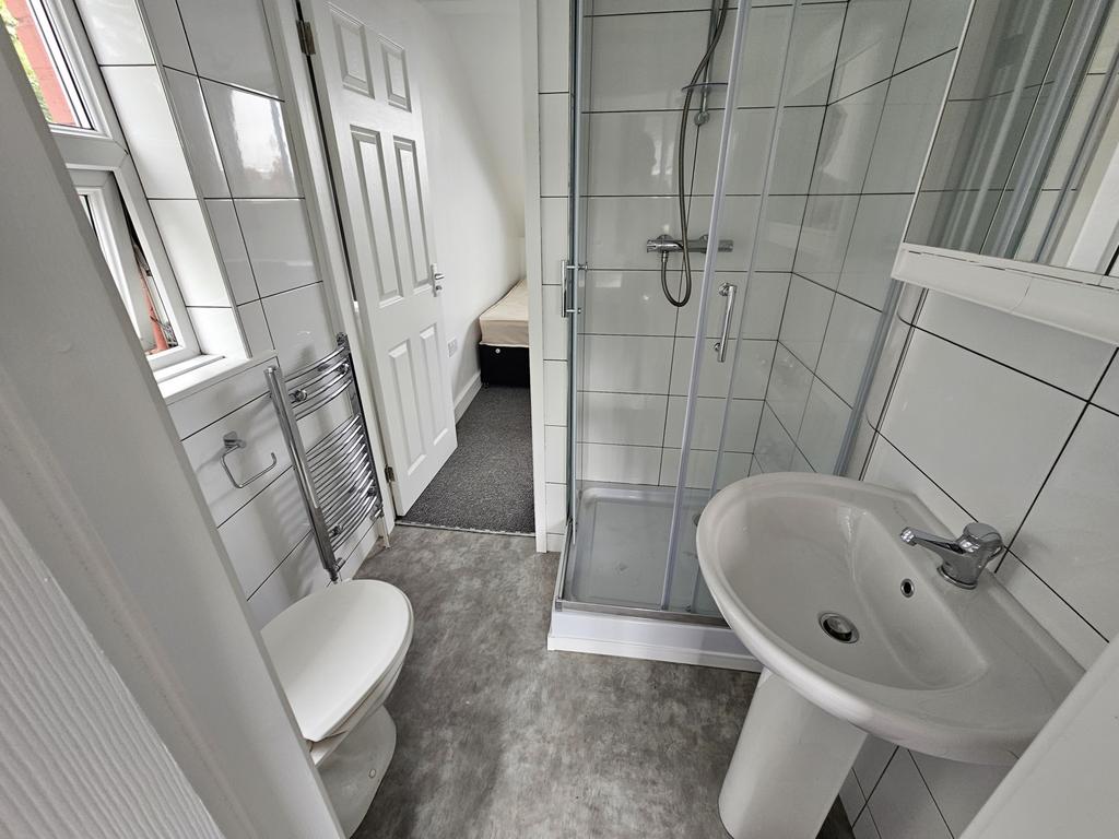 Bright and modern bathroom featuring a clear gl...