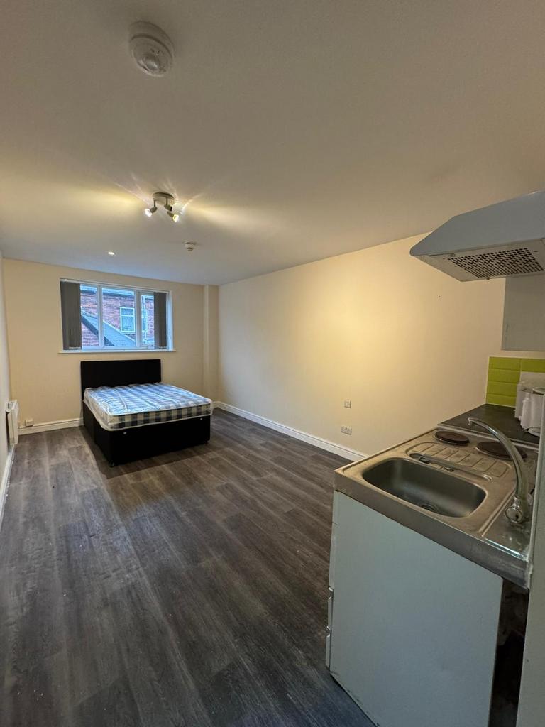 A bright, spacious living area with a large win...