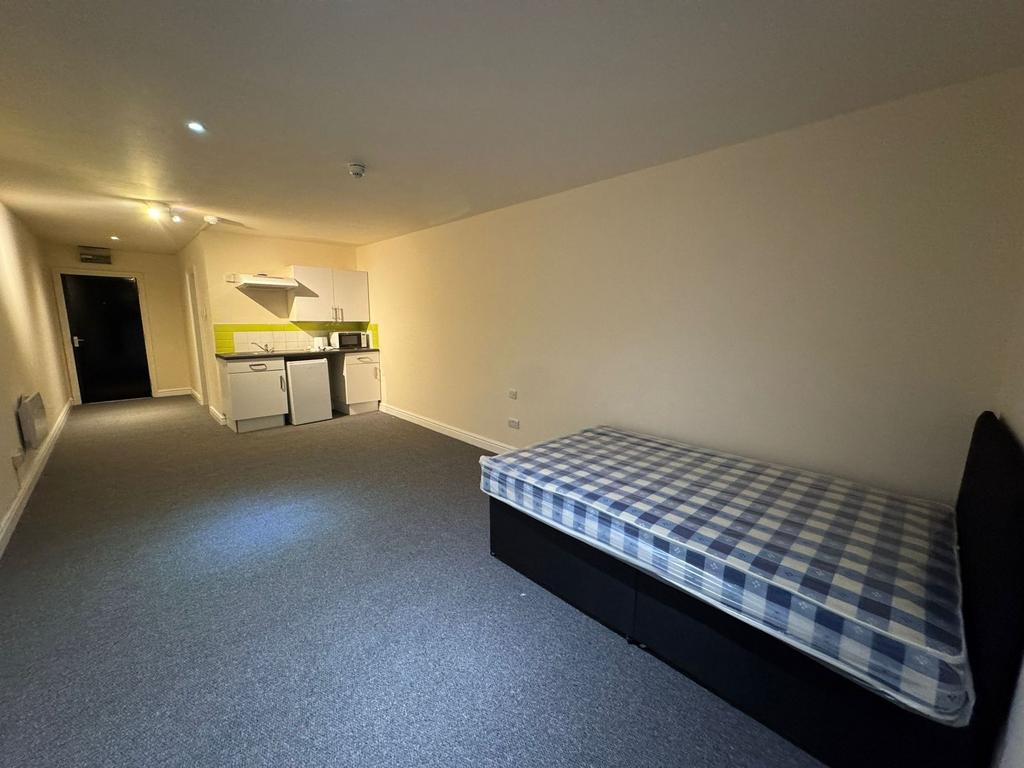 A compact studio apartment featuring a single b...