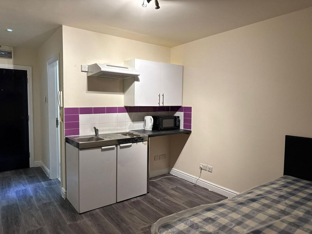 A compact but functional kitchen featuring a sm...