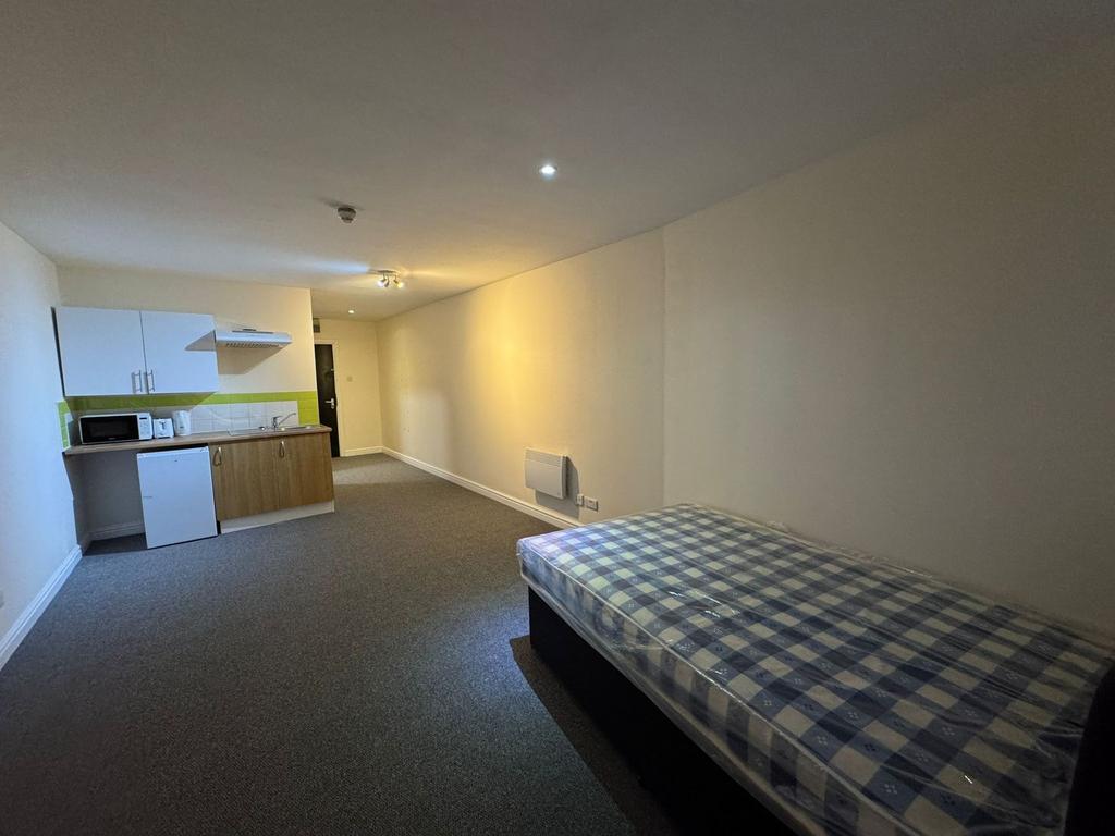 A spacious living room with a comfortable bed a...