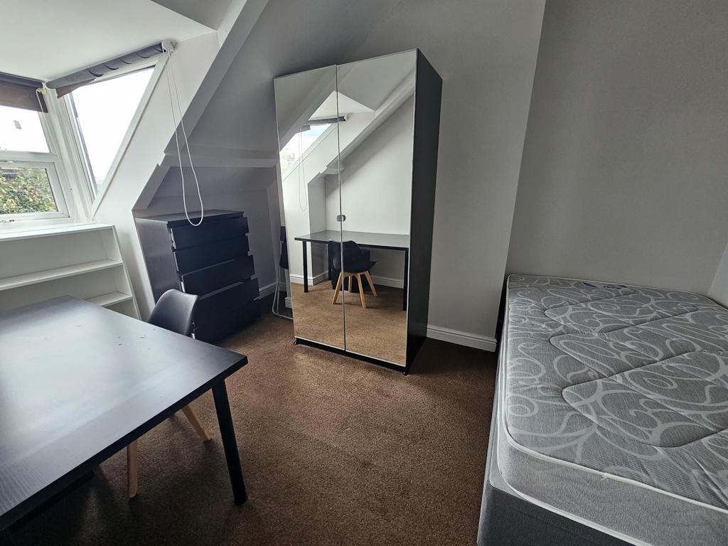 A cozy and well-maintained bedroom featuring a ...