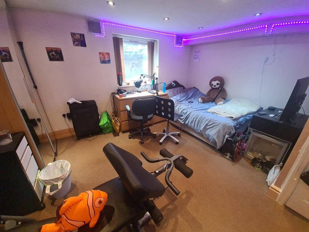 A cozy bedroom featuring a large bed, a study d...