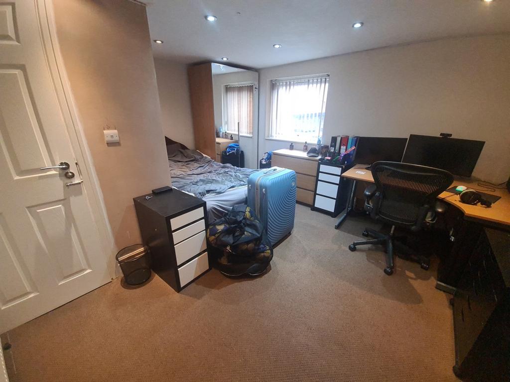 A spacious and comfortable living room featurin...