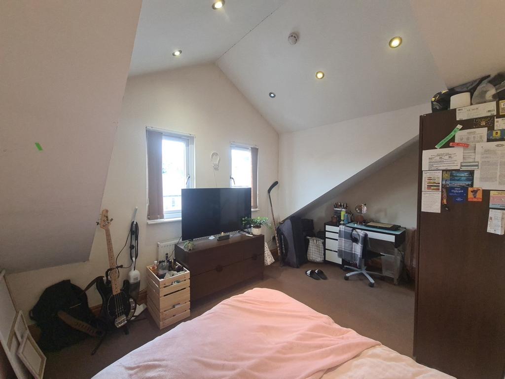 A cozy bedroom with a large window providing na...
