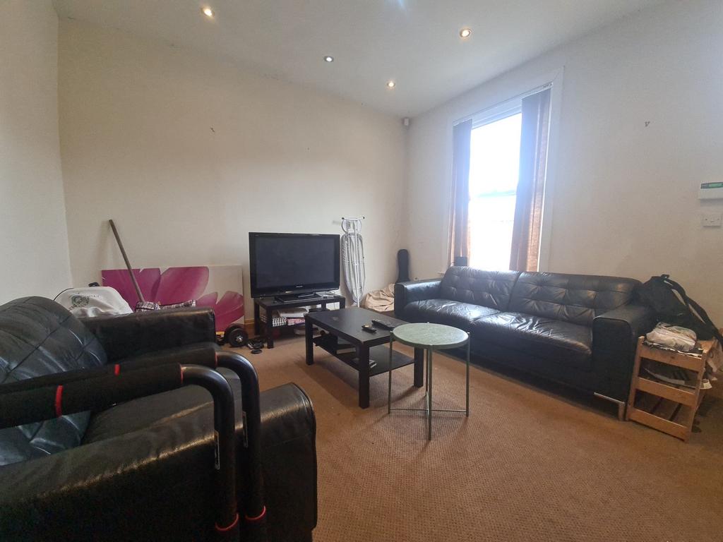 A well-lit, spacious contemporary living room f...
