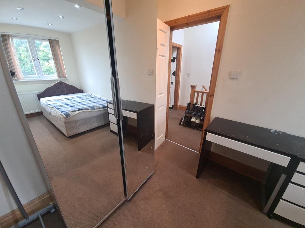 A well-maintained bedroom featuring a double be...