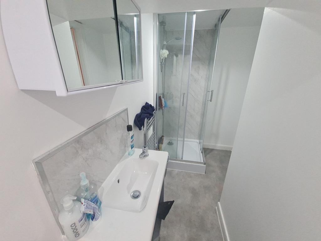 A modern and clean bathroom featuring a bathtub...
