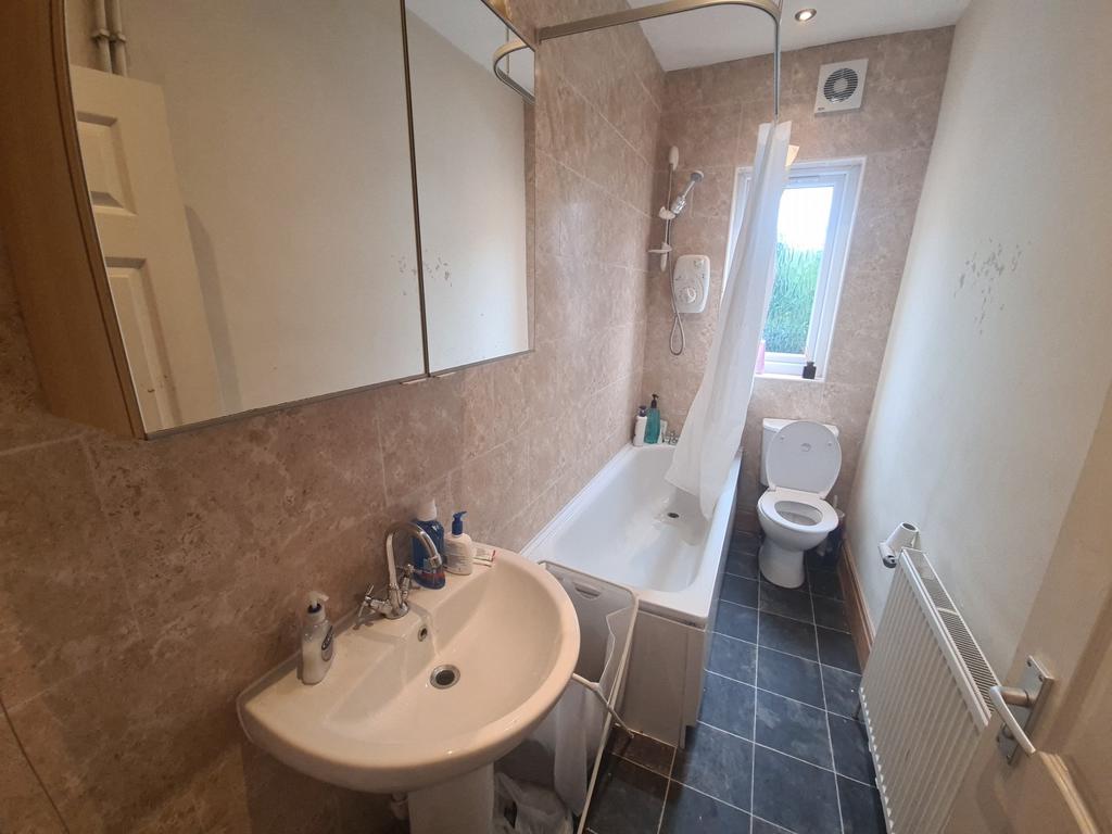 A well-maintained bathroom featuring a bathtub,...