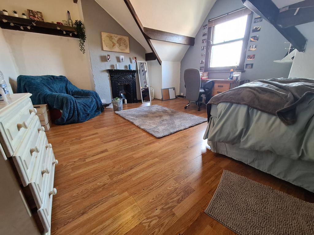 A spacious and inviting master bedroom featurin...