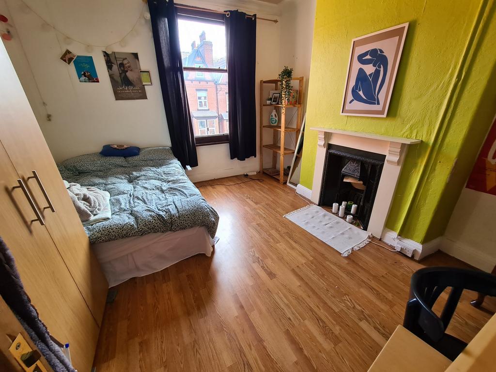 A bright and inviting bedroom with a large wind...