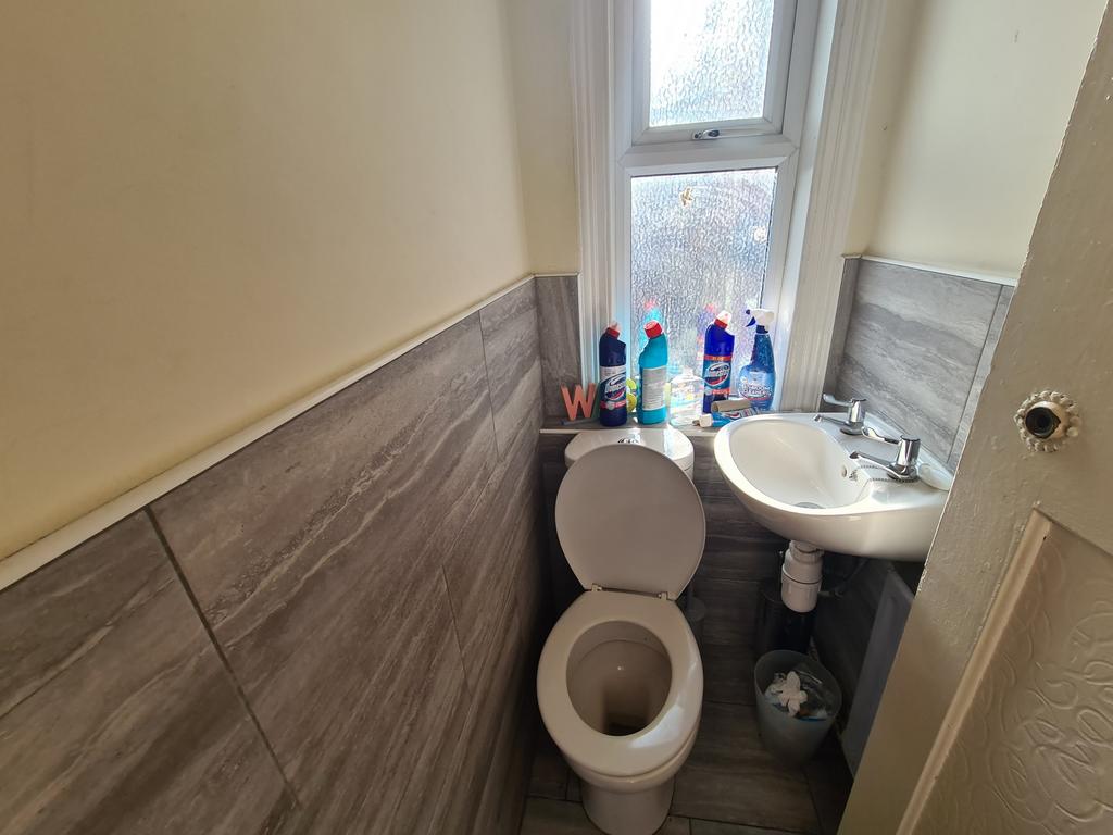 A clean and functional bathroom with a toilet, ...