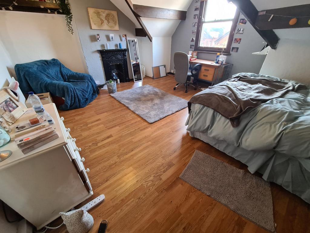 A cozy and well-maintained bedroom featuring a ...