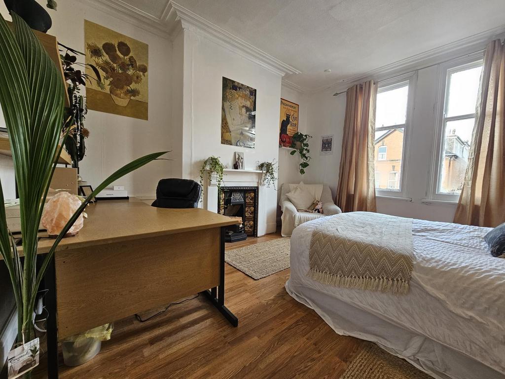 Bright and welcoming living room with ample nat...