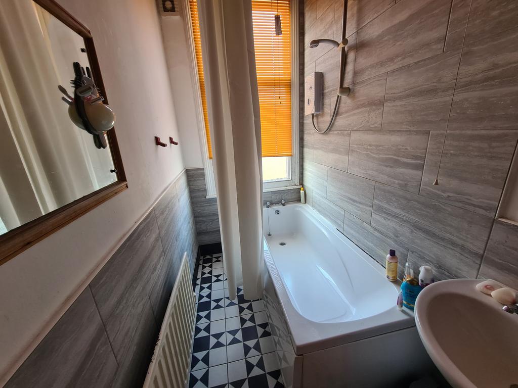 A clean and modern bathroom featuring a large b...