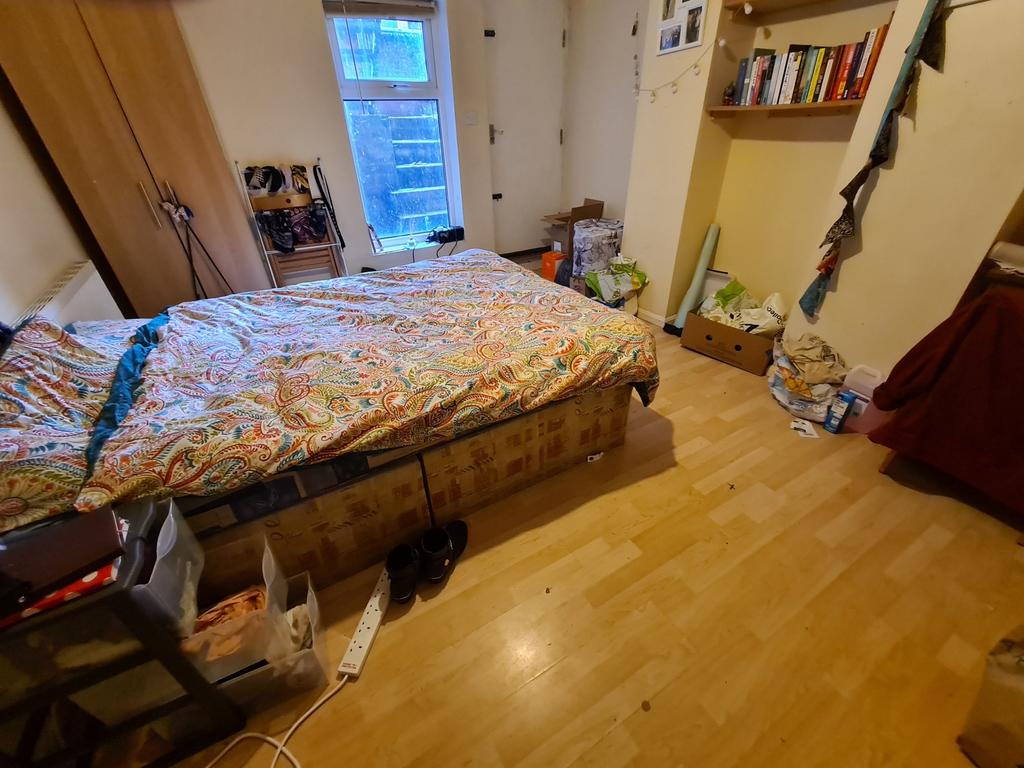 A cozy bedroom featuring a double bed with bedd...