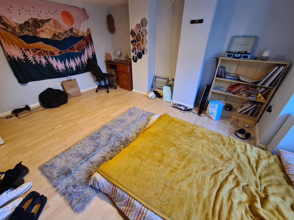 Spacious master bedroom with a large bed and am...