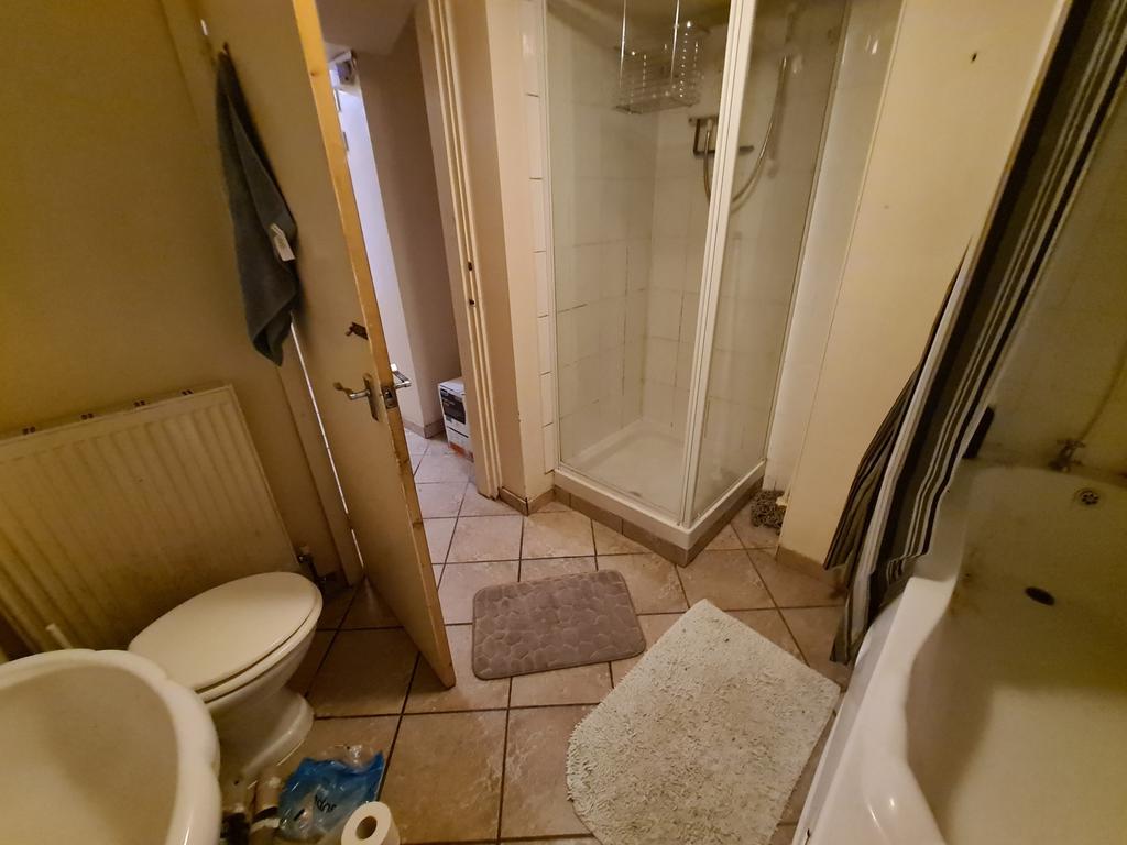 A clean and well-lit bathroom featuring a large...