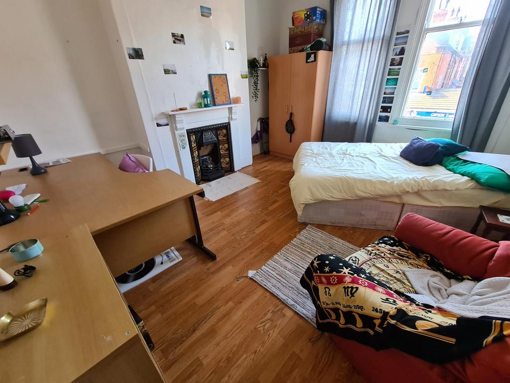 A spacious and bright living room with large wi...