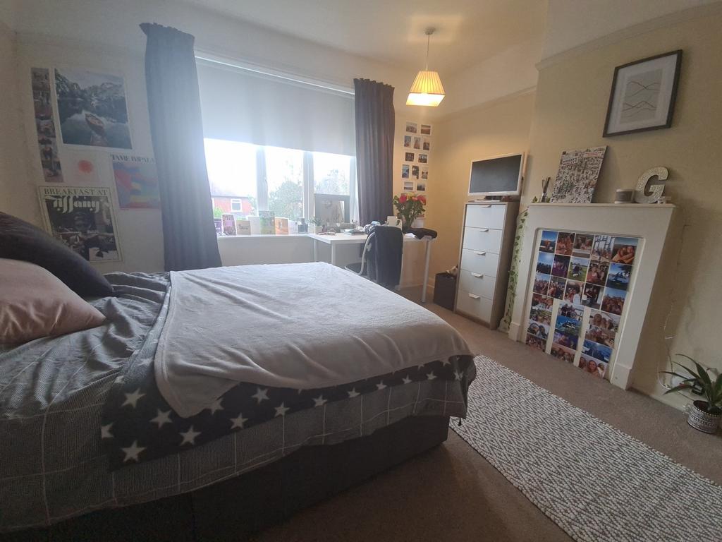 A spacious and inviting master bedroom with amp...