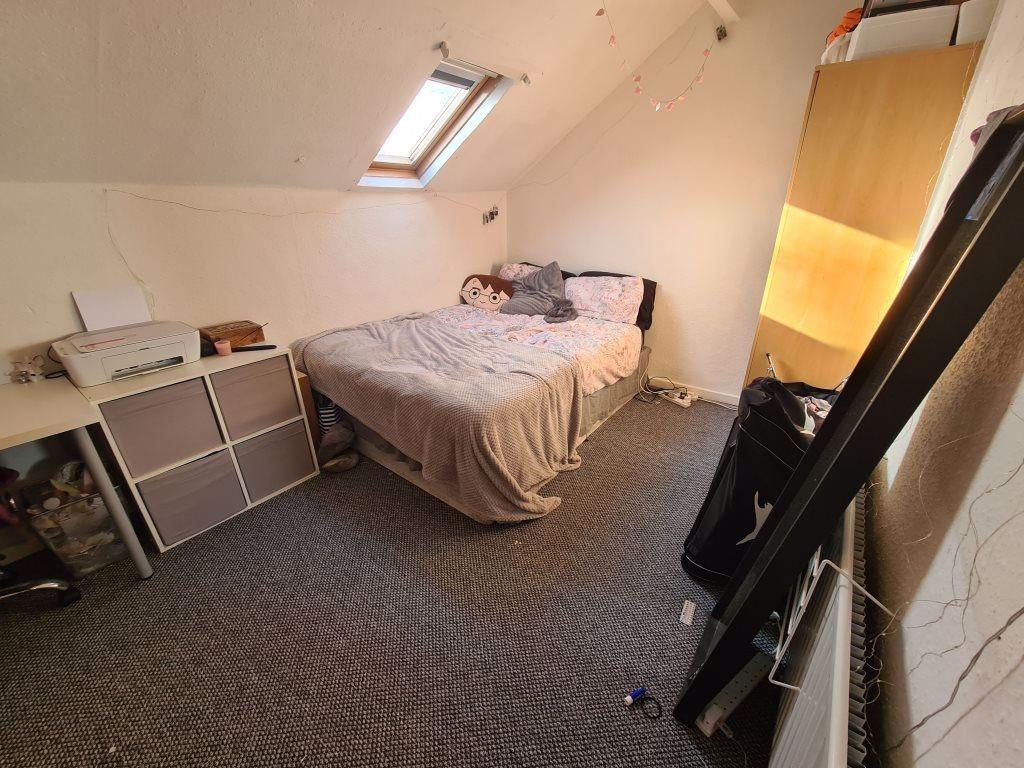 A cozy, well-lit bedroom with a comfortable bed...