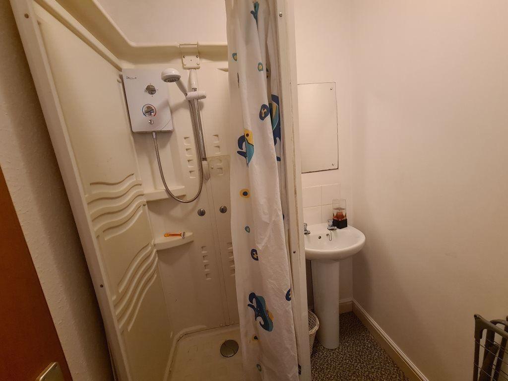 A clean and well-maintained bathroom with basic...