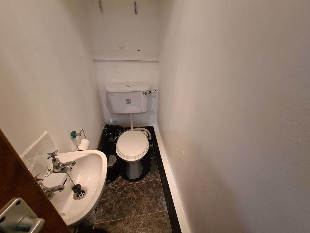 A tidy bathroom featuring a toilet and a small ...