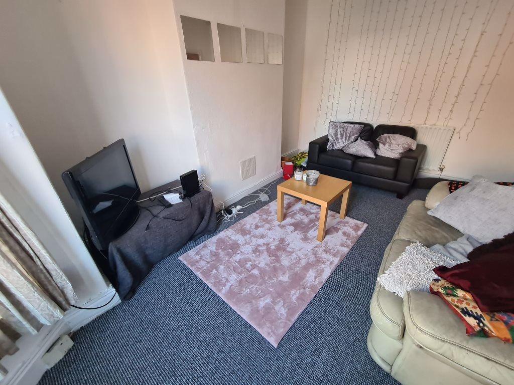 A spacious and welcoming living room featuring ...